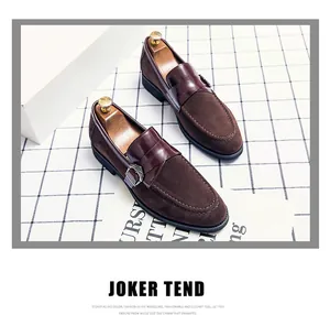 Close-up detail of vintage brown suede men's loafers with smooth leather strap and buckle