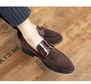 Close-up of brown suede and polished leather men's loafers on a vintage wooden floor