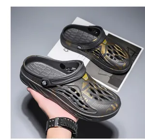 Detailed view of plus-size men's breathable gray clogs with golden graphic prints and non-slip sole