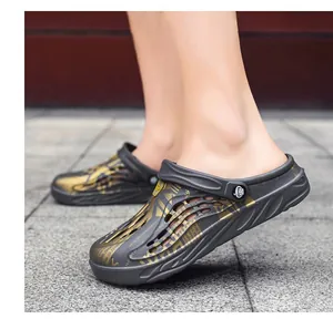 Side detail view of men's clogs featuring gold patterns on outdoor stone pavement