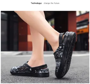 Men's black and grey patterned clogs shown on a street for outdoor wear