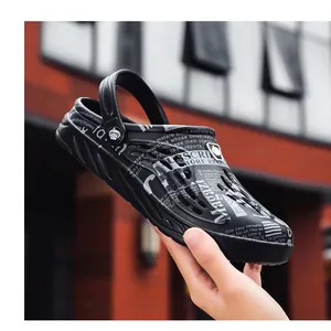 Detail view of men's plus size black clogs with newspaper print design and breathable holes.