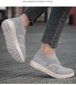Close-up of lightweight grey knit slip-on sneakers with durable white rubber sole