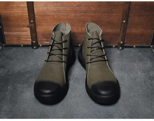 Front view of olive green vintage leather Martin boots for men with black gradient toe.