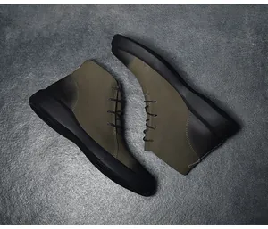 Detailed top view of vintage olive green outdoor Martin boots with textured black sole