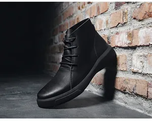 Side view of black leather Martin boots leaning against a rustic brick wall texture