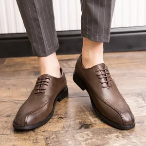 Elegant brown men's pointed-toe leather dress shoes for business and formal occasions