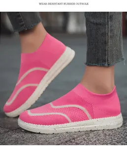 Close-up view of pink knit slip-on sneakers with durable white speckled rubber outsoles
