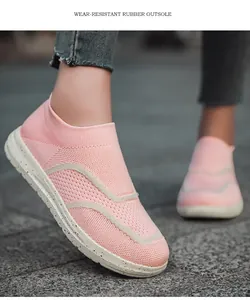 Detail view of pink knitted slip-on sneakers with wear-resistant rubber outsole