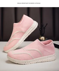 Detailed view of pink knitted slip-on sneakers with speckled wear-resistant soles.