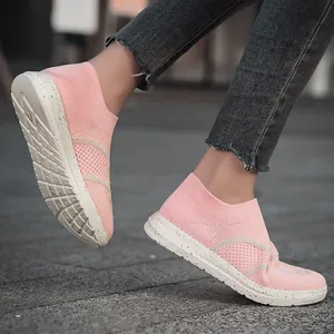 Casual pink knit slip-on sneakers for walking and running featuring a speckled white outsole