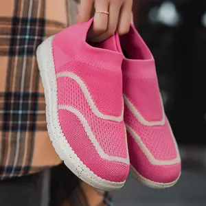Vibrant pink knit slip-on sneakers with stylish wave patterns and speckled soles.