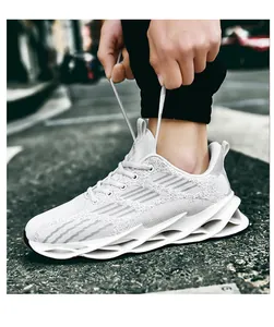 Close-up of white breathable knit blade running shoes for men on street background.