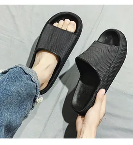 Close-up of black thick-soled cloud slides showing mesh texture and fit on foot