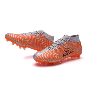 Botas de fútbol de cuello alto naranja y plata con tacos AG para competición juvenil
