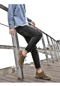 Gedetailleerde lifestyle-opname van ademende kaki outdoor vrijetijdsschoenen op een houten pier