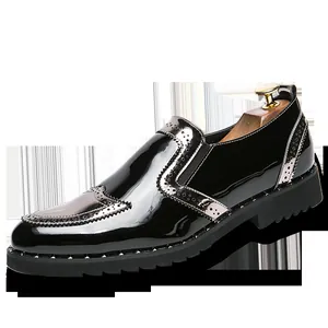 Classic black patent leather brogue loafers with silver metallic accents and studs