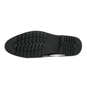 Detailed macro view showing the textured anti-slip black rubber sole of men's brogue shoes