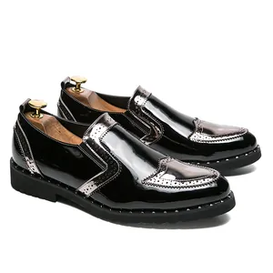 Side view of elegant black patent leather brogue loafers with silver metallic accents