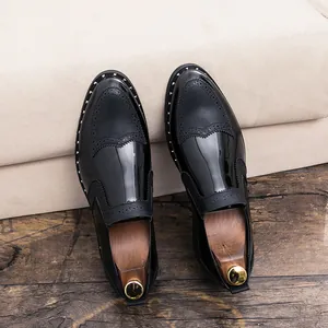 Detail view of black Brogue dress shoes featuring silver rivet trim and patent leather