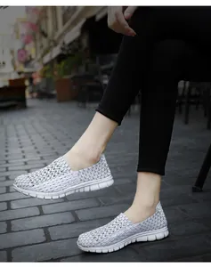 Gros plan de baskets à enfiler tissées grises et respirantes pour hommes et femmes en rue