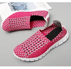 Gros plan de chaussures à enfiler tressées élastiques rose et blanc, maille respirante