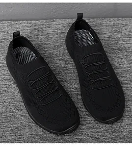 Detail view of the black fly-knit upper and elastic laces on these women's casual slip-on shoes