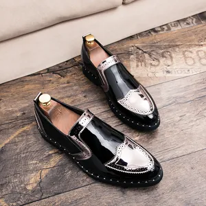 Detailed view of men's black patent leather brogue loafers with silver metallic accents.