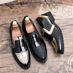 Detailed view of black patent leather brogues with metallic accents and studded soles