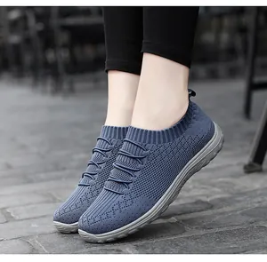 Close-up view of breathable blue fly-knit mesh sneakers for women in a slip-on style