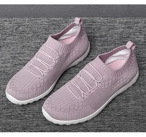 Close-up detail of the breathable pink knit mesh and elastic strap design on sneakers.