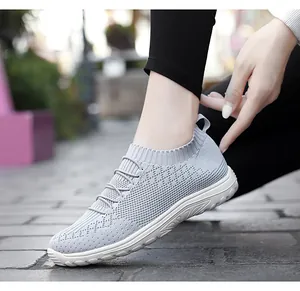 Side view of grey flyknit slip-on walking shoes for women with breathable mesh