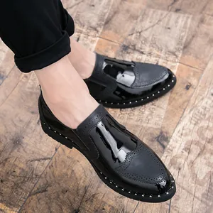 Detail view of men's black brogue shoes with polished finish and decorative silver studs