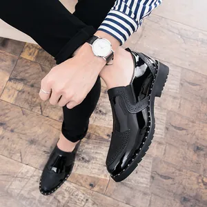 Detail shot of men's black patent leather Brogue shoes with stylish rivet accents