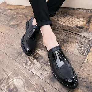 Detailed view of black brogue dress shoes with rivet accents and stylish patent leather