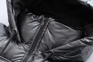 Close-up of metallic black hooded puffer jacket showing zipper and drawstring details