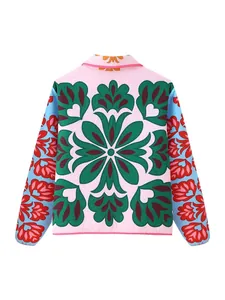 Trendy women's quilted jacket with bold pink and blue floral print, back view.