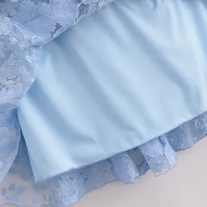 Detailed view of light blue floral lace and smooth satin lining
