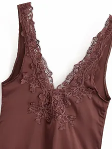 Detail of brown satin bodysuit featuring intricate floral lace trim on V-neckline.
