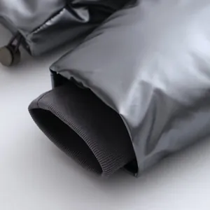 Close-up of metallic shiny puffer jacket cuff with ribbed knit windproof inner sleeve