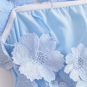 Macro view of light blue 3D embroidered floral decorations on luxury strapless summer dress