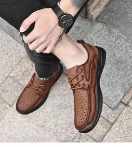 Macro detail of brown perforated breathable men's outdoor leather shoes with black thick sole