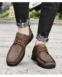 Close-up of brown leather men's outdoor hiking shoes featuring a breathable perforated upper