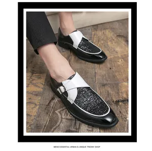 Close-up of men's black patent leather shoes with white strap and glitter vamp detail