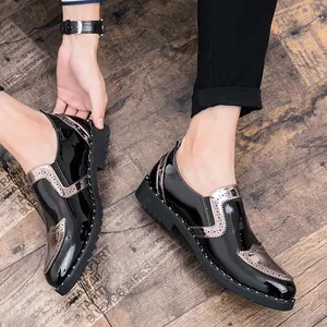 Detailed view of men's black patent leather Brogue shoes with metallic accents