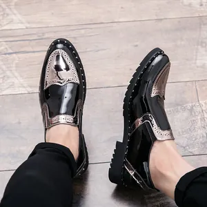 Close-up of black patent leather brogue shoes with silver metallic accents and rivets