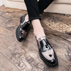 Detailed view of men's black patent leather Brogue shoes with metallic accents and rivets