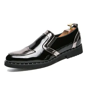 Stylish black patent leather brogue shoes with rivet detailing and slip-on design.