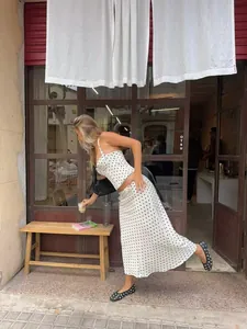 Chic white and black polka dot two-piece skirt set worn in a lifestyle setting
