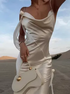 Elegant white satin cowl neck maxi dress for evening parties in a desert setting